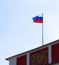 New Russian flag waves atop of an old Soviet USSR Emblem coat of arms