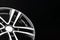 New shiny alloy wheel, color black with silver front. Copy space, close-up of wheel elements