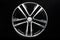 New shiny alloy wheel, color black with silver front. Dark background, front view