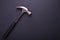 New silver hammer on black granite board background. Composition