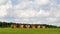 New six brick orange buildings looks like a twins in sunny landskape with white clouds