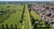 New Skyline of Milan seen from the Milanese hinterland, aerial view, tree lined avenue. Pedestrian cycle path