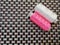 New small bobbins of pink and white sewing thread