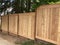 New staggered cedar fencing on slope