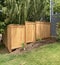 New staggered cedar fencing on sloped yard