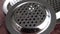 New stainless steel filter on a wooden surface. Kitchen sink strainer. Metal drain cover. Macro