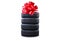 New tires pile as a gift  isolated on white. Tyres pile with a big red bow, as a present or bonus for buying a car