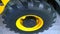 New tractor wheel. Black tire. Yellow disc. Agricultural machinery. Industrial abstract background. Innovations in mechanical engi