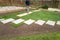 New turf installation within an area with new slab stepping stones, in a newly landscaped garden