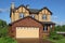 New two-storied brown cottage with built-in garage