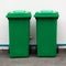 A new unbox green large bins ready to use on footpath and white concrete wall