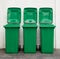 A new unbox green large bins ready to use on footpath and white concrete wall