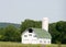 New white barn with green roof