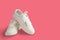 New white female or teen sneakers isolated on white background. White textile sneakers with rubber soles with tied laces on a