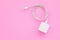 New white smartphone charger on pink background with copy space for text or design