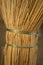 New wicker broom handle closeup with green ropes