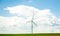 New windmill in green fresh fields in the spring cumulus cloud