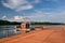 New wooden molo with small tower on Kamencove jezero alum lake in czech city of Chomutov at evening after rain in June 2018