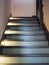 A new wooden staircase with illuminated steps in a private house