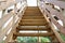 New wooden staircase outdoors in summer day