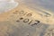 New Year 2017 is coming concept - inscription 2016 and 2017 on a beach sand