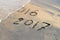 New Year 2017 is coming concept - inscription 2016 and 2017 on a beach sand