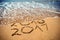 New Year 2017 is coming concept - inscription 2017 and 2016 on a beach sand, the wave is covering digits 2016. New Year 2017 celeb