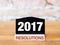 New year 2017 resolutions text on blackboard sign on wood table