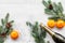 New Year 2018 celebration with spruce branch, oranges, champagne and glasses white table background top view mock up