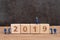 New year 2019 begin concept, cute miniature people worker staffs finish building cube wooden block as year number 2019 on wood