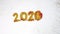 New year 2019 change to 2020 concept, The wind blew red glittery glitter from 2019 to 2020 yellow glitter, isolated on white backg