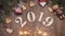 New year 2019 concept. Christmas theme. Wooden numerical symbols 2019 placed on wooden background. Bengal fire all