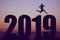 New year 2019 silhouette with jumping man as symbol for changes