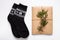 New year 2020 flat lay.Christmas black ornamental socks,gift box in eco kraft paper with pine tree cones.Winter holidays