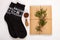 New year 2020 flat lay.Christmas black ornamental socks,gift box in eco kraft paper with pine tree cones.Winter holidays
