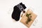 New year 2020 flat lay.Christmas black ornamental socks,gift box in eco kraft paper with pine tree cones.Winter holidays
