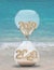 New Year 2020 hourglass on ocean beach
