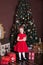 New Year 2020. Merry Christmas, happy holidays. Portrait of a little girl with a candle. Little girl holds a candle in front of a