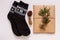 New year 2021 flat lay. Black ornamental socks, gift box in eco kraft paper with pine tree cones. Zero waste Christmas