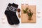 New year 2021 flat lay. Black ornamental socks, gift box in eco kraft paper with pine tree cones. Zero waste Christmas