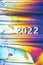 New Year 2022 number on the trendy colorful neon holographic background with polarization effect.