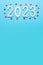 New year 2023. 2023 on a blue background. Copy space. Place for text. Layout for design. Vertical. Wooden numbers. Flat