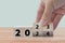New year 2023 change to 2024. Hand flip over wooden cube block. New year holiday concept