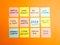 New Year 2023 resolutions handwritten on colorful sticky notes on orange background. Future planning, motivation, change and