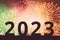 New Year 2023. Silhouette of large black numbers against a background of multicolored fireworks. Copy space. The concept