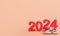 New year 2024 holiday concept. Gold number 2024 lies at 2023 with blank empty background