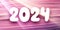 New Year 2024 horizontal banner with numbers made of white paper on bright pink textured background with sun lights