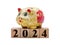 New Year 2024: piggy bank and toy blocks isolated