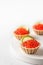 New year appetizer tartlets stuffed with red caviar and a slice of lime on a white background with text space