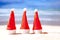 New year on the beach. Three Christmas hats on the beach against the backdrop of the ocean, copy space